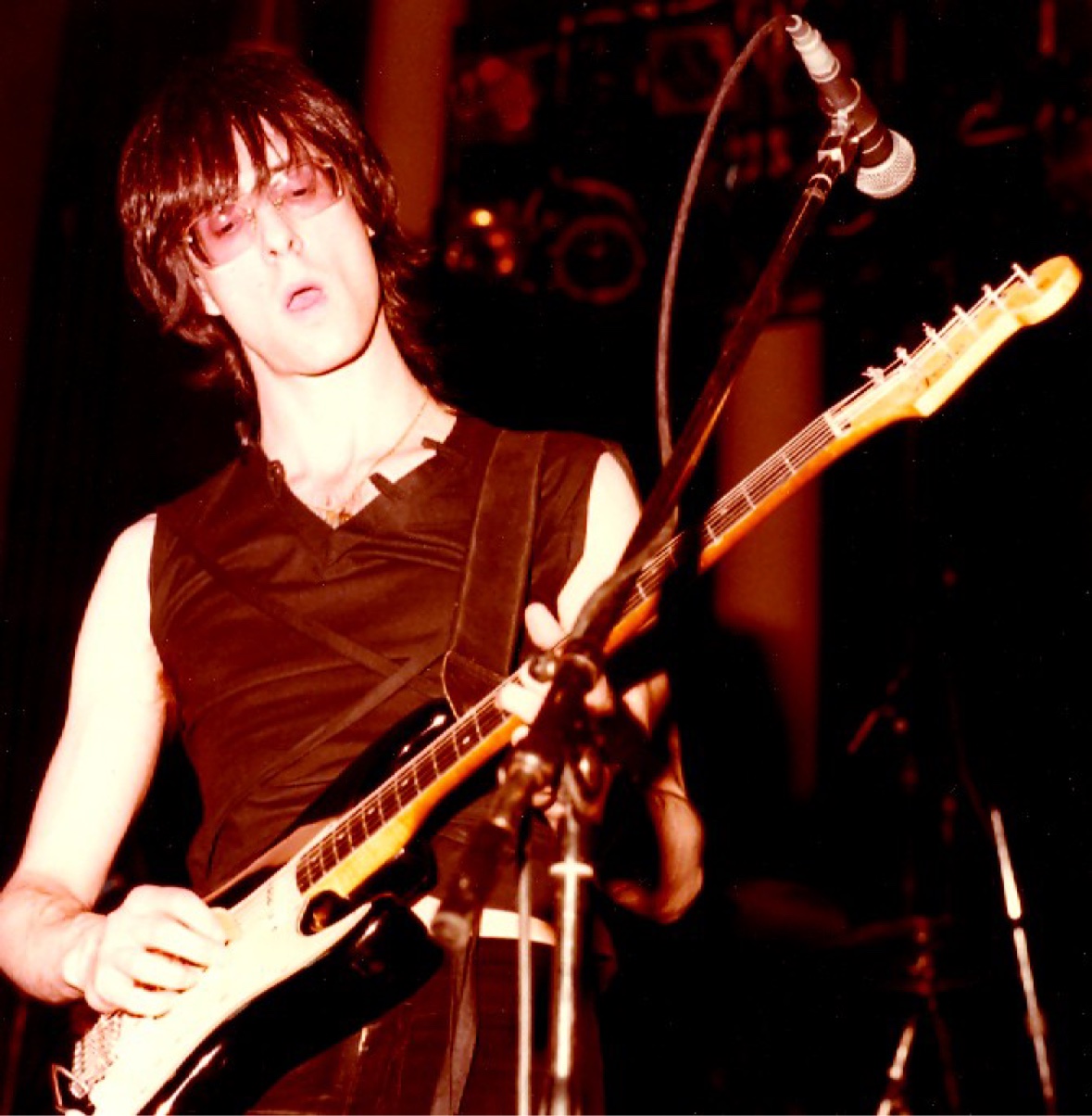 A young Lenny Kaye playing a Stratocaster live on stage